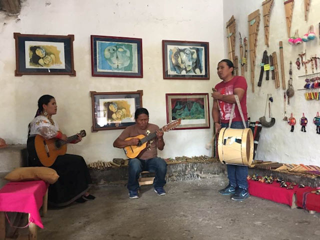 Music Man family playing handmade instruments