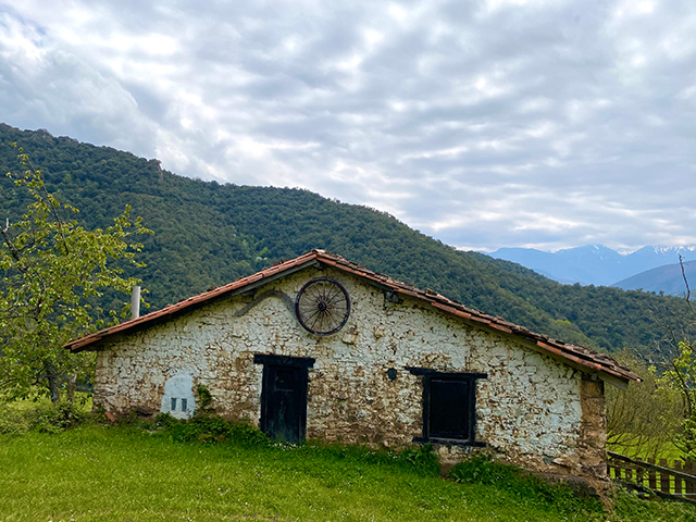 This low brick building was a monastery according to a sign we find on the other side of this valley where those dark green trees are….farther down the path.