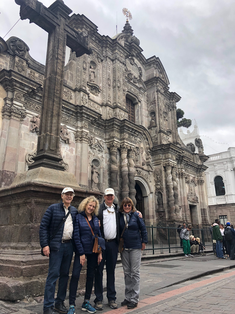 New View Tours travelers again caught in this pix In front of the amazing cathedral finally completed by 1600 by the Jesuits in Quito Ecuador - La Compania. The facade is carved stone repeated inside in gold painted wood that looks like the real metal!